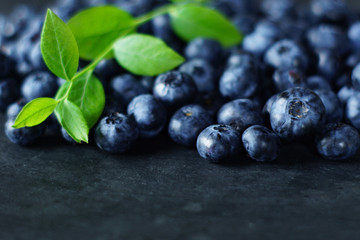 Blueberries on slate with blueberry leaf, macro blueberry   