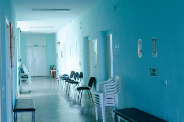 Empty hospital hallway. Close up. Rays of light in the corridor of the hospital. waiting wheelchair. quarantine isolation. epidemic Coronavirus, MERS-CoV, 2019-nCoV, Covid-19 self-isolation, pandemic
