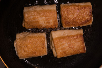 Frying pancakes with fillings on a skillet.