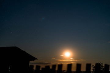 Night sky against the background of village buildings