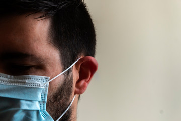 Portrait of a male with blue mask in an interior space