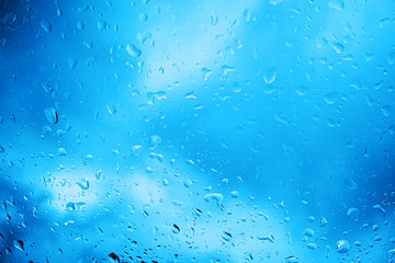 Blue water drops on the glass