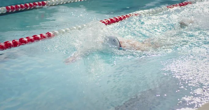 Male swimmer swimming freestyle stroke