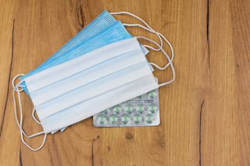 Several hygienic  COVID 19 masks with medicine pills