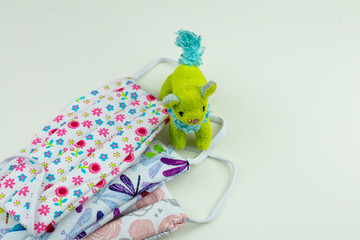 Several, colorful COVID 19 masks for children