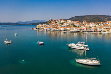 Fototapeta premium Top aerial view of the Poros island Sea harbor, Aegean sea, Greece. Panoramic view of city Poros