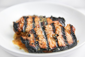 Classic grilled pork chop on white plate