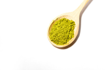 Green powder of Japanese matcha tea in a teaspoon. Matcha on a white background, isolated