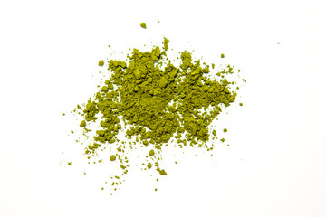 Green powder of Japanese matcha tea on a platter, isolated on a white background. Loose powder