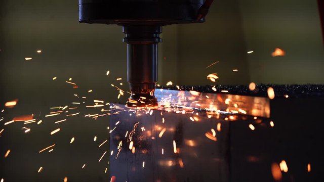 The CNC milling machine rough cutting  the injection mold parts with burning chip from tool wear. The mold and die manufacturing process by machining center with the index-able tools.