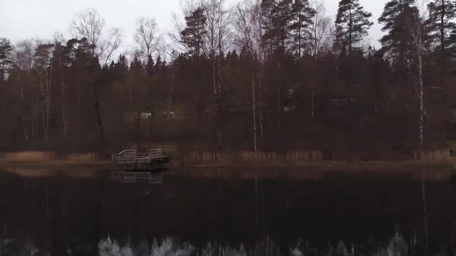 Several boats parked against the edge of the lake in Sweden.