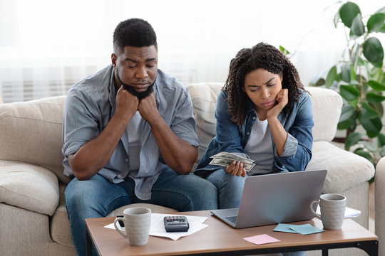 Financial Problems. Upset Black Couple Managing Family Budget Together At Home