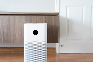 Indoor air purifier with digital monitor screen in bedroom, that show air quality in the room and air pollution levels in the room. PM 2.5 is a major environmental health problem affecting everyone.