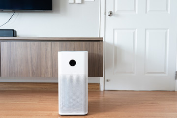 Indoor air purifier with digital monitor screen in bedroom, that show air quality in the room and air pollution levels in the room. PM 2.5 is a major environmental health problem affecting everyone.