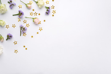 flower composition with spangles stars on white background corner, top view, flat lay, copy space