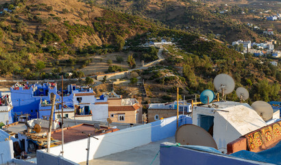 Blue roofs of the Chefchaouen town, Morocco. Medina of the Blue city on the side of the Rif mountains. Travel to North Africa. Numerous television antennas on the roofs of a residential buildings