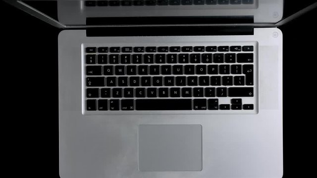 A man working on a laptop online from his home. Top down view.