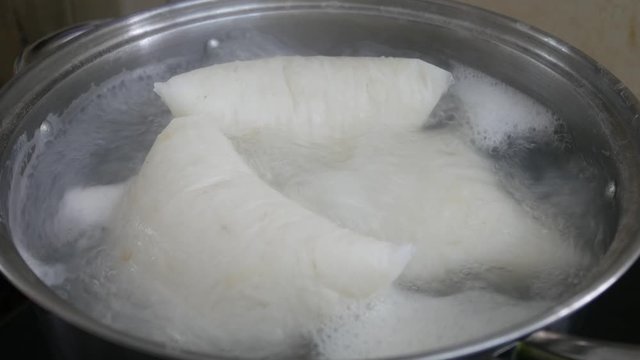 Nasi Impit or pressed rice in the plastic pack is boiled using hot water in a pan. Nasi Impit is usually cooked by Malay Muslims during Eid Celebration in Malaysia.
