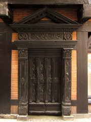 Fototapeta premium Door of a house with wooden formwork structure, pediment and carving details. Historic city if Albi. France. 