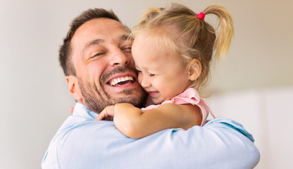 Caucasian dad holding his cute loving daughter