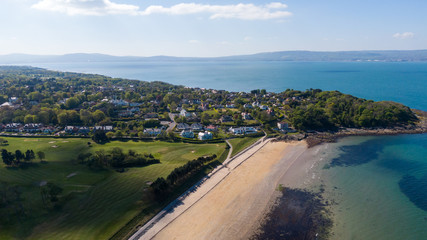 Fototapeta na wymiar Aerial view of Coast of Irish Sea in Helen's Bay, Northern Ireland. View from above on beach in sunny day