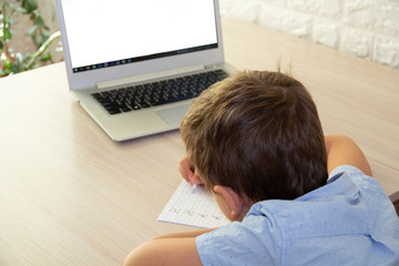 the boy learns at home to write a prescription distance learning for kids