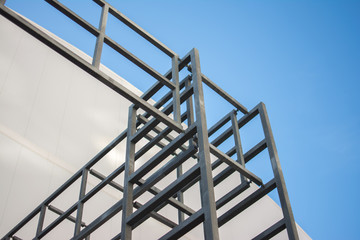metal structures made of pipes of a building under construction against the blue sky