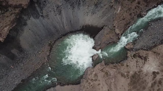 Top Down Aerial View of Waterfall and Volcanic Cliffs and Canyon, Chile, Yeso Dam Outflow