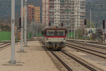Obraz premium Small motor passenger train with red modern electric engine in Trencin station