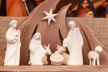 Christmas nativity scene wooden figurines inside a wooden house representing the holy family © Nataliia