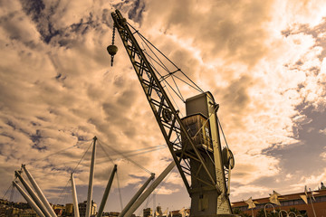 old crane at the ancient port of Genoa at sunset