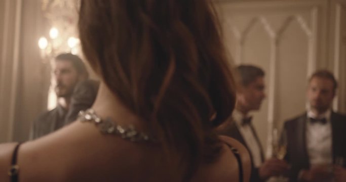 Beautiful young couple dancing at party. Young man and woman dancing romantically at gala dinner party.
