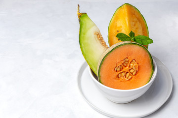 Fresh assortment melon with mint  on white