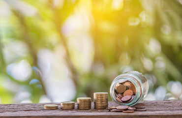 Coins are stacked on a natural background wood,