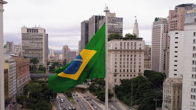 Aerial view of brazilian flag fluttering and Cha viaduct in background, Sao Paulo downtown, Brazil