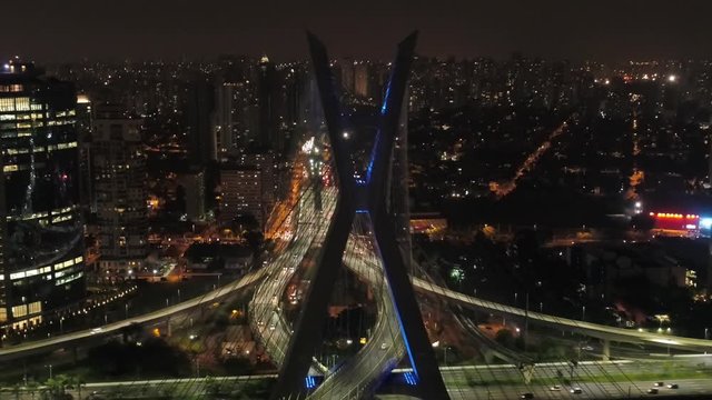 Aerial view of Estaiada bridge, at night with the buildings in background, Brazil