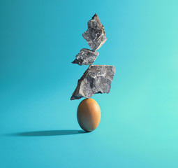 Three stones put on Egg. creative idea. Balance concept