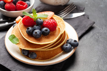 Delicious pancakes with berries and coffee
