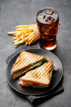 Club sandwich, potato fries and cola