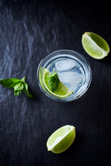 Gin and Tonic on black stone background.