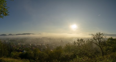 Fototapeta na wymiar Sunrise and sunset, beautiful clouds over the meadow, hills and buildings in the town. Slovakia