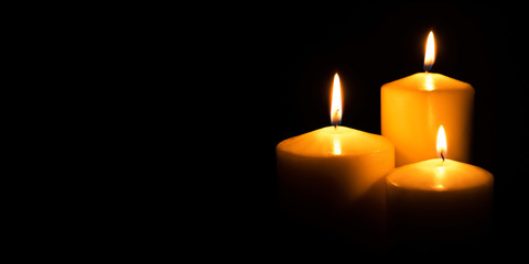Flame candles isolated on black background. Close up. - obrazy, fototapety, plakaty