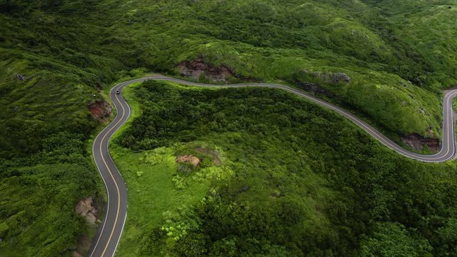 A Lone Offroad Vehicle Driving On The Narrow Winding Island Hana Highway, Maui, Aerial Orbit