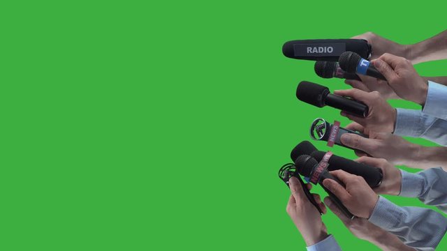 Crowd of paparazzi holding microphones sideways to get an interview from famous film star