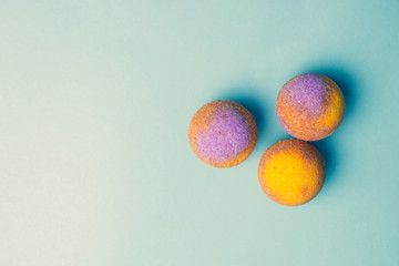 Shop natural cosmetics, bright salt bombs for baths handmade on a blue background. Top view.