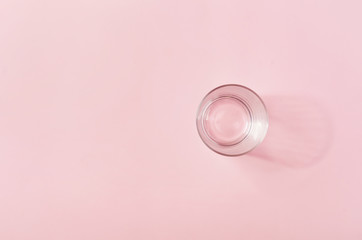 empty glass on a light pink background