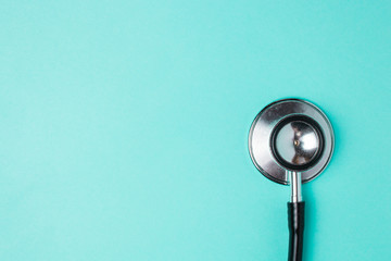 old shabby stethoscope on a blue background with copyspace