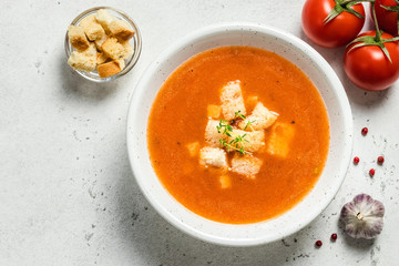 Creamy basil tomato soup. Top view, copy spce.