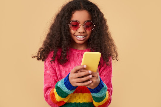 Modern black kid using smartphone