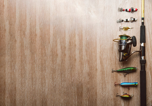 Fishing tackle-fishing spinning, lures on a wooden background.
